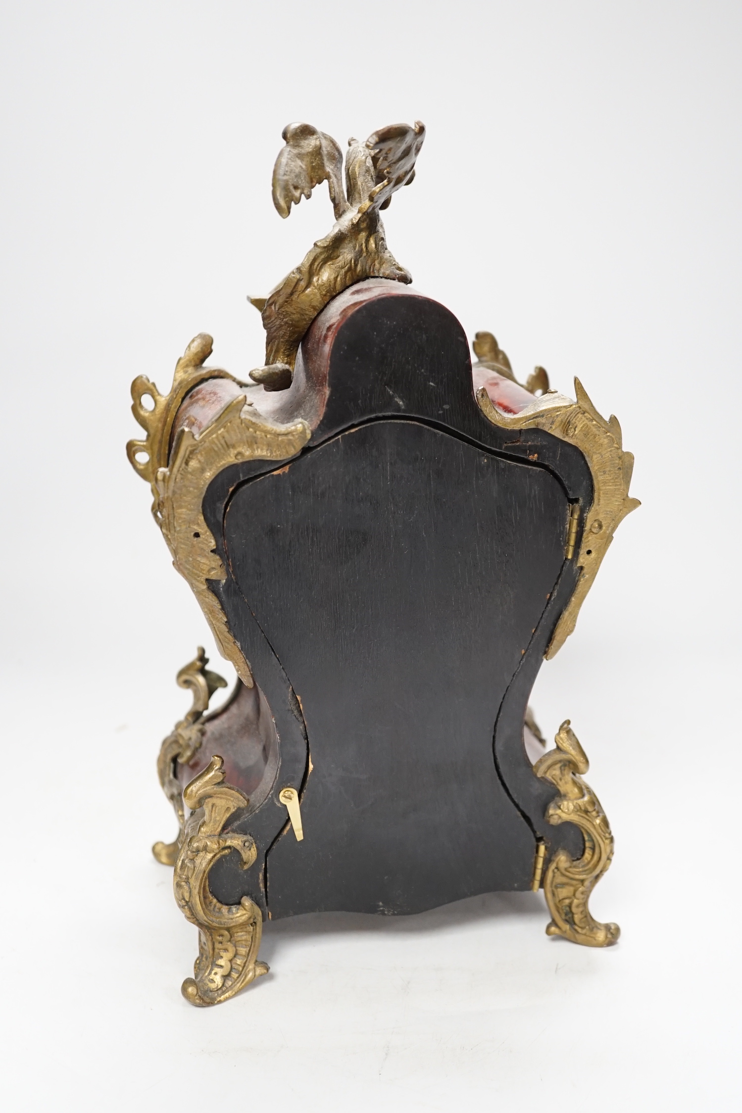 An early 20th century French red tortoiseshell veneered mantel clock with dragon mount, 30cm